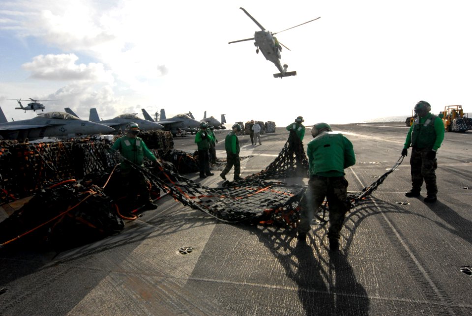 US Navy 080823-N-7730P-016 Supply Department personnel spread and fold a cargo net used to transfer supplies during a replenishment at sea aboard the aircraft carrier USS Ronald Reagan (CVN 76)