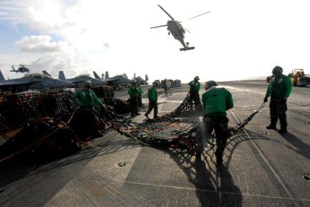 US Navy 080823-N-7730P-016 Supply Department personnel spread and fold a cargo net used to transfer supplies during a replenishment at sea aboard the aircraft carrier USS Ronald Reagan (CVN 76) photo