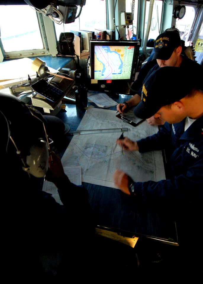 US Navy 080822-N-4044H-060 Quartermaster 2nd Class Carlos Oqendo plots points on the navigation chart aboard the guided-missile destroyer USS McFaul (DDG 74)