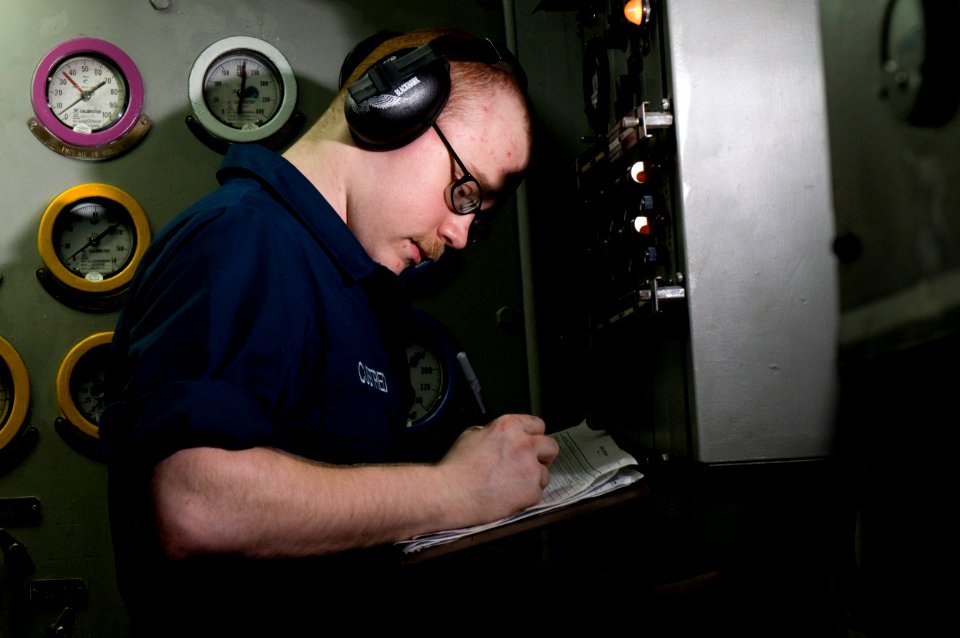US Navy 120110-N-TZ605-152 Engineman Fireman Damian Custred charts gauge readings in an emergency diesel generator space