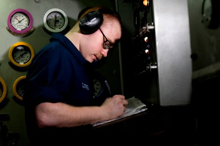 US Navy 120110-N-TZ605-152 Engineman Fireman Damian Custred charts gauge readings in an emergency diesel generator space