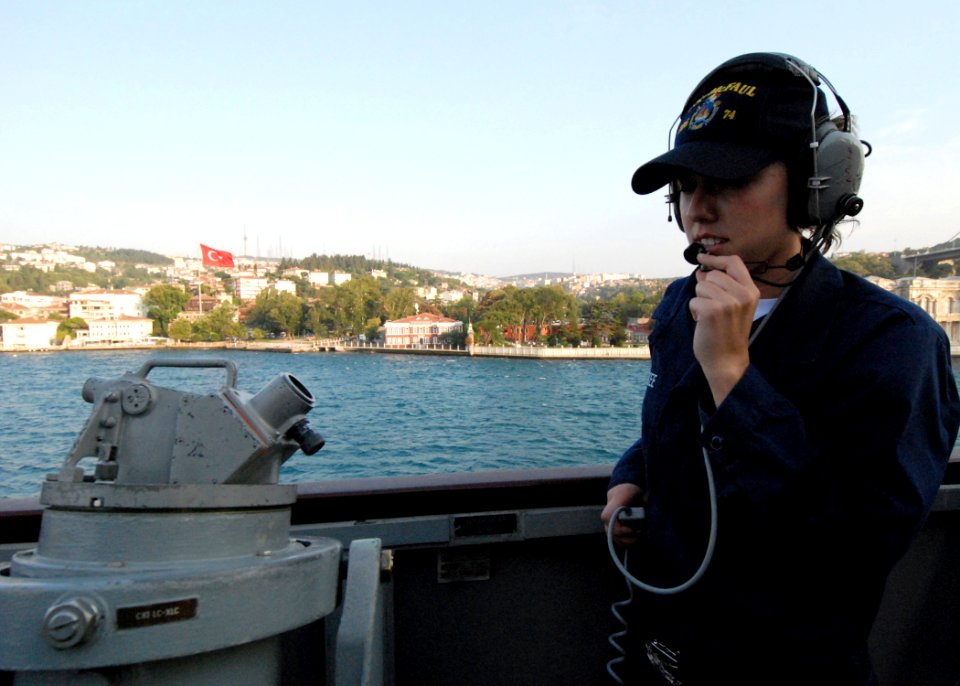US Navy 080822-N-4044H-029 ) Quartermaster Seaman Apprentice Ashley McKee relays bearings-from-land readings taken from a telescopic alidade to the quartermasters inside the pilothouse aboard the guided-missile destroyer USS Mc