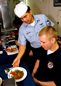 US Navy 080820-N-7280V-018 Hull Maintenance Technician 3rd Class Paris Luh enjoys an Asian-Pacific meal