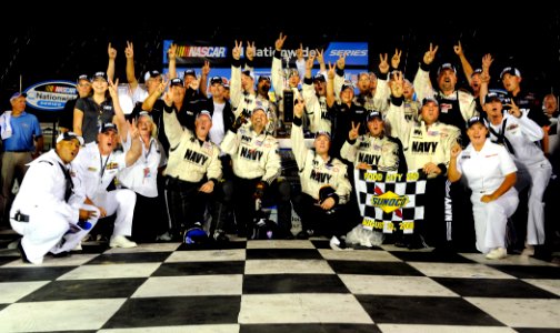 US Navy 080822-N-5345W-262 Sailors assigned to Riverine Squadron (RIVRON) 1 celebrate in victory lane with the JR Motorsports U.S. Navy team