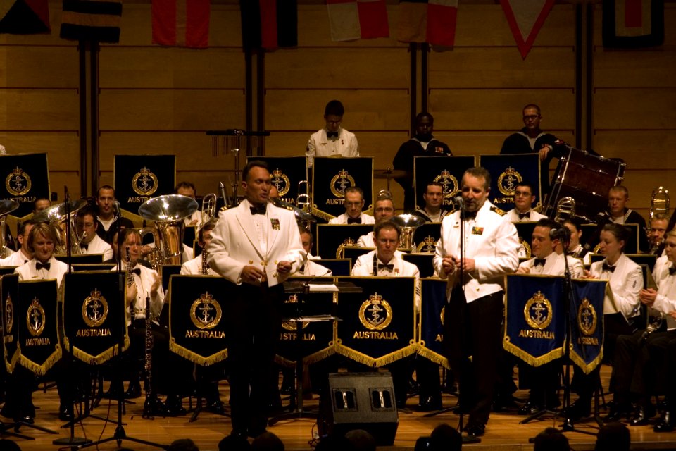 US Navy 080822-N-9123L-004 Royal Australian Navy Band Leader Lt. Cmdr. Phillip Anderson introduces Lt. Bruce McDonald during the Royal Australian Navy's presentation of