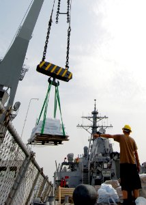 US Navy 080825-N-4044H-050 Boatswain's Mate 2nd Class Santos R. Torres guides the crane barge driver aboard the guided-missile destroyer USS McFaul (DDG 74)