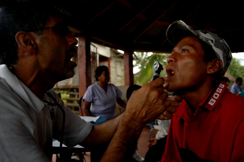 US Navy 080823-N-7544A-078 Project HOPE volunteer, Dr. Dale Rai examines a patient