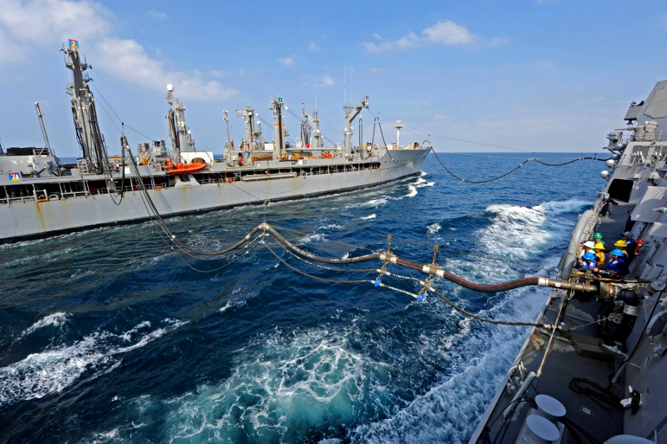 US Navy 111229-N-VH839-037 The Arleigh Burke-class guided-missile destroyer USS Dewey (DDG 105) receives fuel at two fueling stations