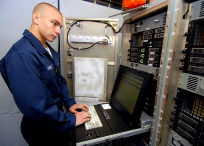 US Navy 080823-N-9079D-037 Information Systems Technician Seaman Joel V. Lasko, from Salisbury, Conn., performs backups on Centrixs in the tactical automated information systems center aboard the aircraft carrier USS Abraham Li