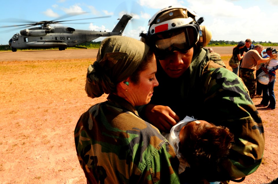 US Navy 080821-N-4515N-670 Cmdr. Angelia Elum-Oneal hands an Operation Smile patient to Lt. Cmdr. Maria Norbeck
