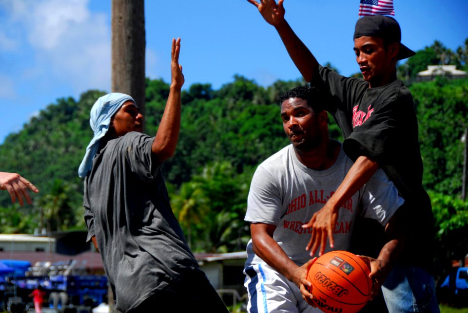US Navy 080823-N-9689V-004 Sailors assigned to the Military Sealift Command hospital ship USNS Mercy (T-AH 19) play basketball with residents of Weno Island at a local field