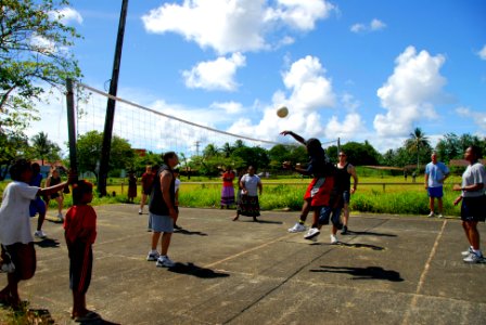 US Navy 080823-N-9689V-005 Sailors assigned to the Military Sealift Command hospital ship USNS Mercy (T-AH 19) play volleyball with residents of Weno Island at a local court
