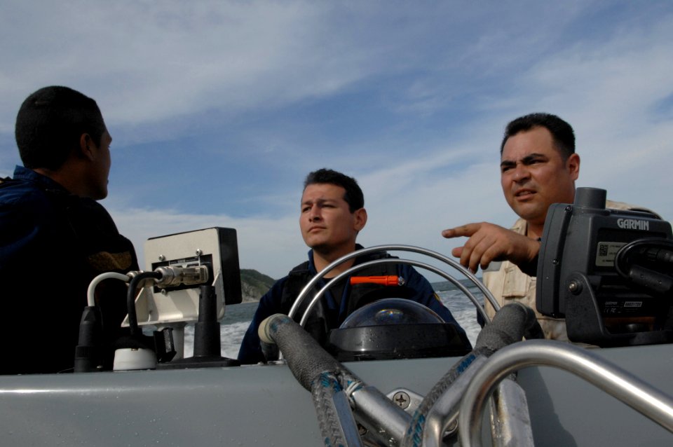 US Navy 080902-N-7544A-070 Chief Boatswain's Mate Daniel Chavez and two Colombian Coast Guard members drive a rigid inflatable boat