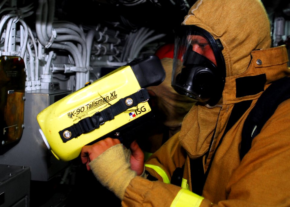 US Navy 080827-N-0807W-092 Mineman 3rd Class Wes Akin performs an equipment test on the naval firefighting thermal imager