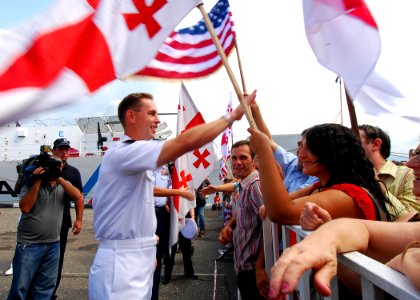 US Navy 080827-N-4044H-075 Local Georgians greet Capt. John Moore, commodore, Combined Task Force 367, shortly after the arrival of the U.S. Coast Guard Cutter Dallas (WHEC 716)