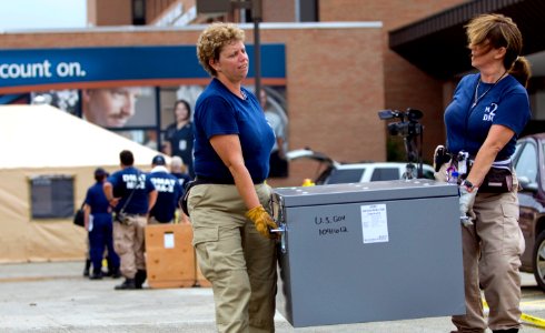 US Navy 080903-N-4154B-061 Two members from the FEMA Disaster Medical Assistance Team move boxes of equipment