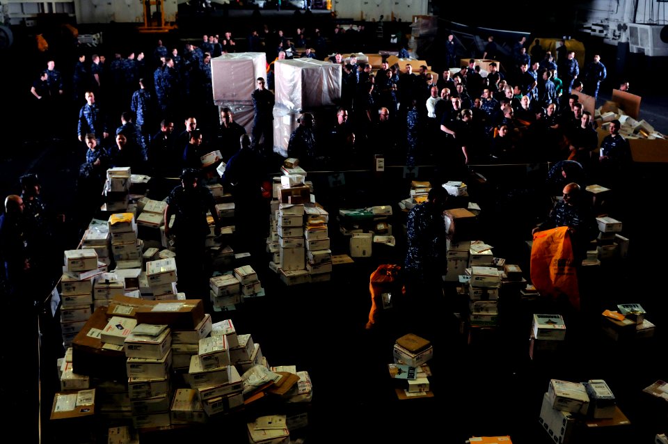 US Navy 111230-N-ZI635-584 Sailors line up for their packages during mail call aboard the Nimitz-class aircraft carrier USS Carl Vinson (CVN 70)