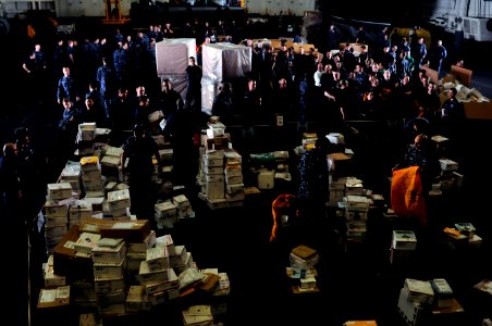 US Navy 111230-N-ZI635-584 Sailors line up for their packages during mail call aboard the Nimitz-class aircraft carrier USS Carl Vinson (CVN 70)