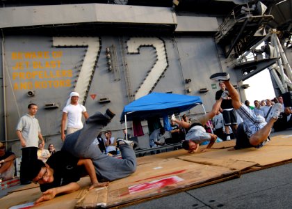 US Navy 080822-N-9079D-083 Sailors break dance on the flight deck during a steel beach picnic aboard the Nimitz-class aircraft carrier USS Abraham Lincoln (CVN 72)