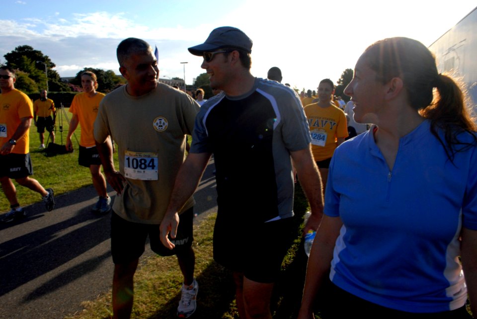 US Navy 080823-N-9818V-308 Master Chief Petty Officer of the Navy (MCPON) Joe R. Campa Jr. speaks with Aircrew Survival Equipmentman 1st Class Chad Lukenbill as they make their way to the start line of the fourth annual