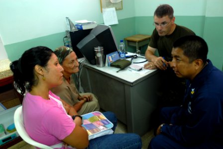 US Navy 080829-N-3595W-047 Canadian Army Capt. Maximilian Callahan speaks with patients at a Candeleria medical clinic