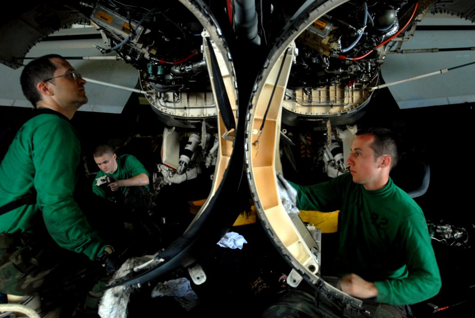 US Navy 080829-N-3610L-003 Aviation Machinist's Mate 3rd Class Jean Boucher and Aviation Machinist's Mate Airman Roger Hunter clean the internal paneling of an F-A18F Super Hornet