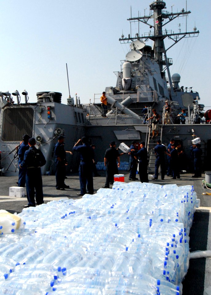 US Navy 080824-N-4044H-114 Sailors aboard the guided-missile destroyer USS McFaul (DDG 74) unload humanitarian supplies to be put on to pallets and then transported to the people of Georgia