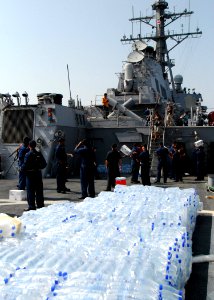 US Navy 080824-N-4044H-114 Sailors aboard the guided-missile destroyer USS McFaul (DDG 74) unload humanitarian supplies to be put on to pallets and then transported to the people of Georgia