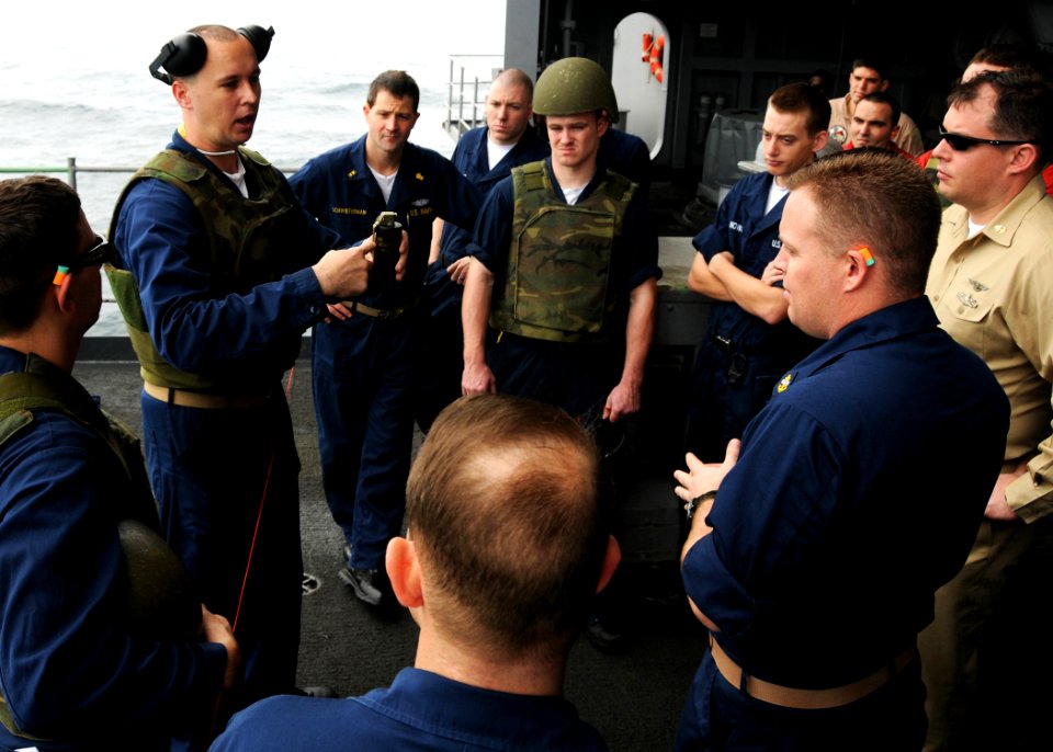 US Navy 080826-N-9898L-001 Chief Gunner's Mate Norman Banks instructs personnel from the aircraft carrier USS Abraham Lincoln (CVN 72) on the proper deployment techniques for the G911 hand grenade during ordnance training off t