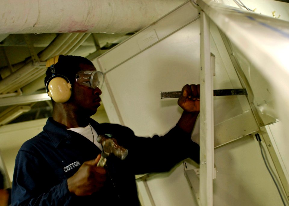 US Navy 080826-N-7280V-315 Seaman LaRoy Cotton breaks down a berthing rack