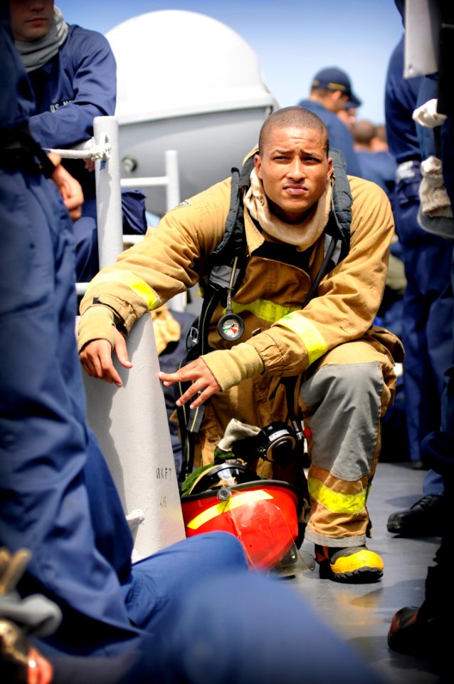 US Navy 080826-N-8546L-312 Machinist's Mate Fireman Mark Buckley Jr. takes a knee