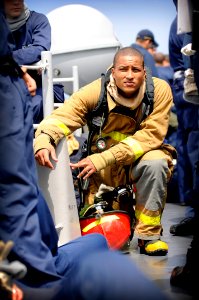 US Navy 080826-N-8546L-312 Machinist's Mate Fireman Mark Buckley Jr. takes a knee