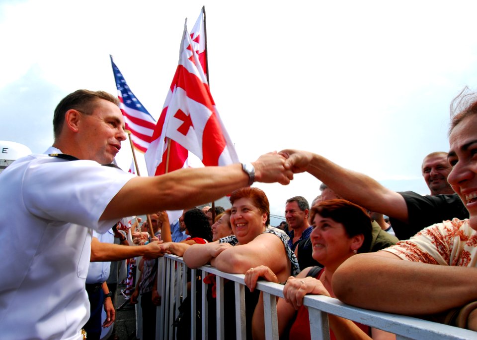 US Navy 080827-N-4044H-081 Local Georgians greet Capt. John Moore, commodore, Combined Task Force 367, shortly after the arrival of the U.S. Coast Guard Cutter Dallas (WHEC 716)