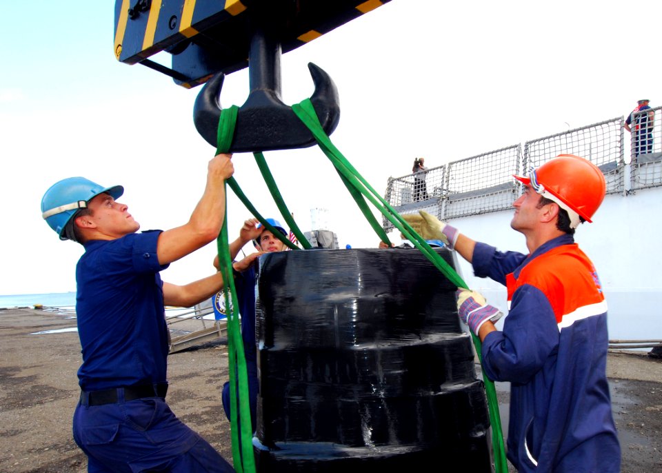US Navy 080827-N-4044H-111 U.S. Coast Guard Seaman Tyler Lewis and U.S. Coast Guard Seaman Ryan Youngblood assist a Georgian pier worker as a pallet of humanitarian assistance supplies is transported from the U.S. Coast Guard C