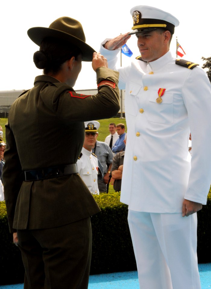US Navy 080829-N-8848T-907 Ensign Brandon Boyles, from Charleston, S. C., receives a first salute from his Drill Instructor Gunnery Sgt. Sandra Center