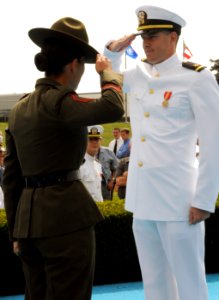 US Navy 080829-N-8848T-907 Ensign Brandon Boyles, from Charleston, S. C., receives a first salute from his Drill Instructor Gunnery Sgt. Sandra Center photo