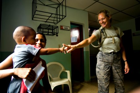US Navy 080831-N-9620B-377 Air Force Master Sgt. Mary Sarris shares a moment with a local Colombian boy