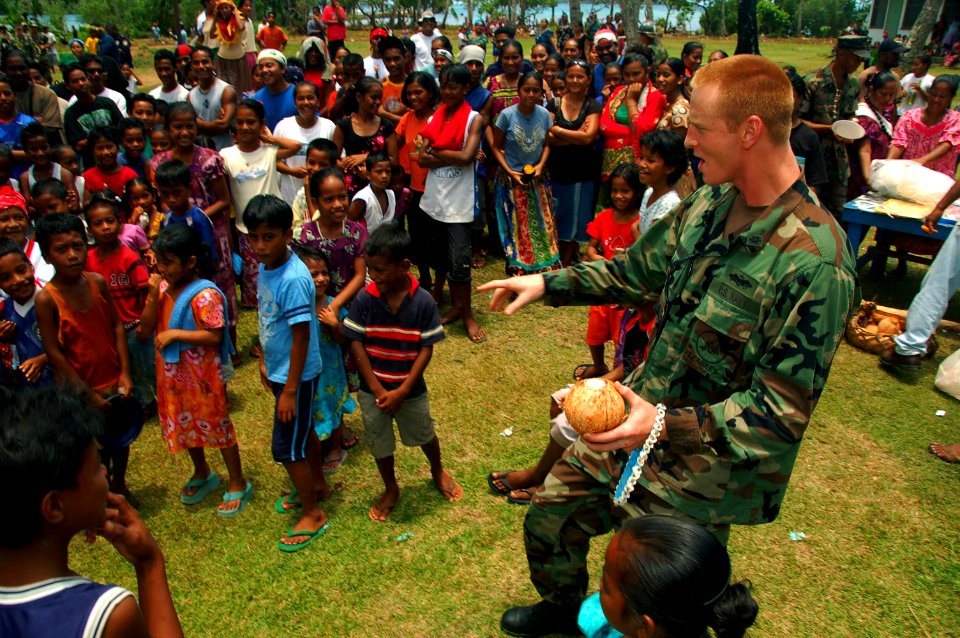 US Navy 080901-N-7498L-440 Naval Mobile Construction Battalion (NMCB) 133 Detachment Officer-in-Charge Lt. Lars Herman dances with the locals during a ribbon cutting ceremony at the Messa Elementary School