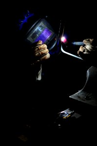 US Navy 080828-N-4515N-181 Hull Maintenance Technician 1st Class Gregory Beene welds a fitting to an air-pipe