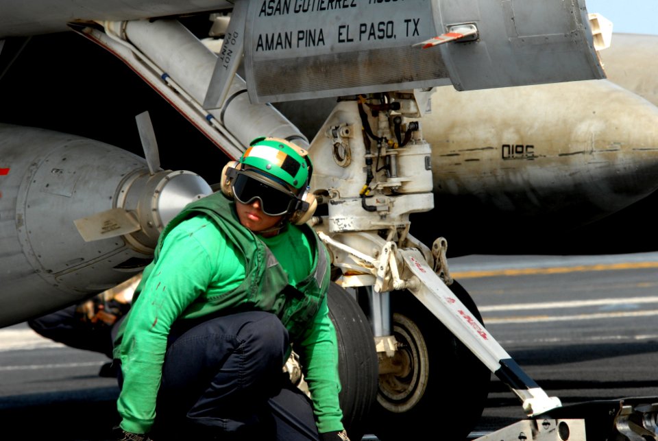 US Navy 080901-N-7730P-006 viation Boatswain's Mate (Equipment) 3rd Class Claudia Flores waits to give the signal to advance an F-A-18E Super Hornet
