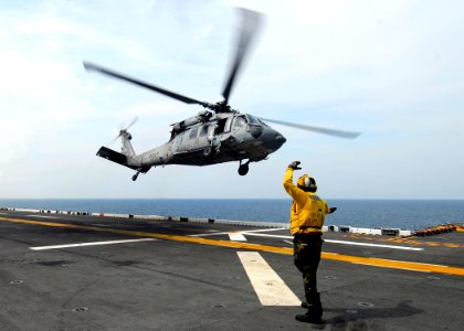 US Navy 080829-N-4236E-189 Aviation Boatswain's Mate Handling Airman Tyrone Williams signals to an MH-60S Sea Hawk from Helicopter Sea Combat Squadron (HSC) 26 aboard the multi-purpose amphibious assault ship USS Iwo Jima (LHD photo