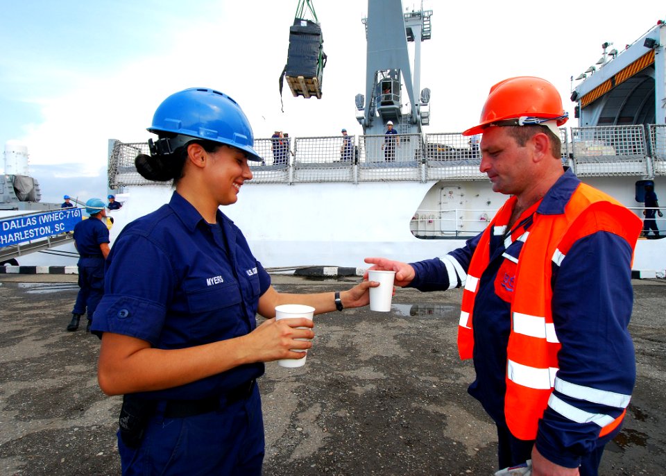 US Navy 080827-N-4044H-117 U.S. Coast Guard Seaman Keri Myers gives a Georgian port worker a glass of water, while a pallet of humanitarian assistance supplies is being off-loaded from the U.S. Coast Guard Cutter Dallas (WHEC 7