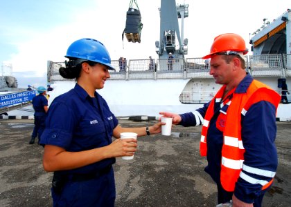 US Navy 080827-N-4044H-117 U.S. Coast Guard Seaman Keri Myers gives a Georgian port worker a glass of water, while a pallet of humanitarian assistance supplies is being off-loaded from the U.S. Coast Guard Cutter Dallas (WHEC 7