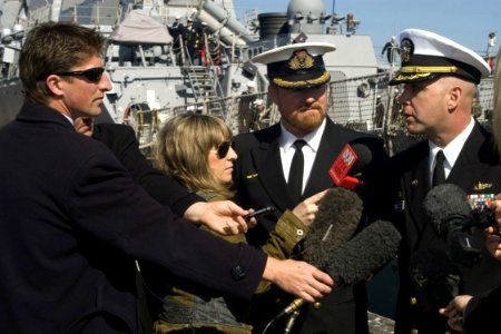 US Navy 080829-N-9123L-004 Cmdr. John S. Banigan answers questions from local media