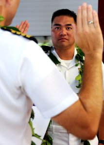 US Navy 080902-N-9758L-046 Native Hawaiian Cmdr. Mel Yokoyama, executive officer of Cruise Missile Support Activity, Pacific, listens to the oath of appointment during his promotion ceremony at the U.S. Pacific Fleet boathouse