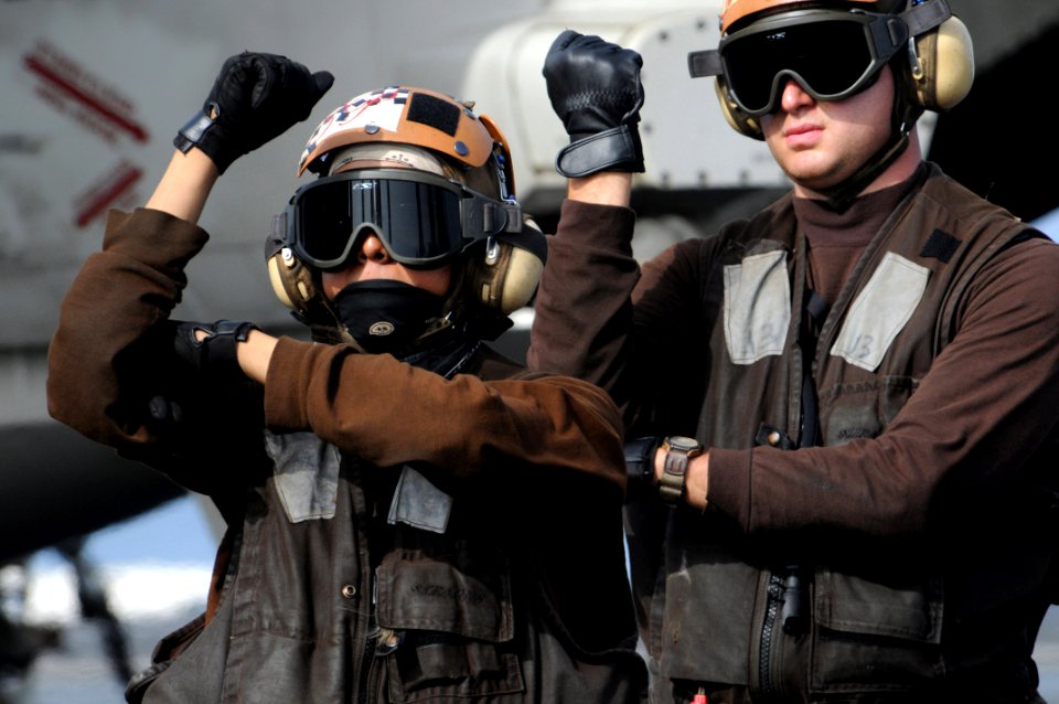 US Navy 080828-N-3659B-371 Aviation Machinist's Mate Airman Shawn Connors mimics the movements of Aviation Machinist's Mate Airman Carlos Hernandez during the pre-flights checks on an F-A-18C Hornet during flight operations abo