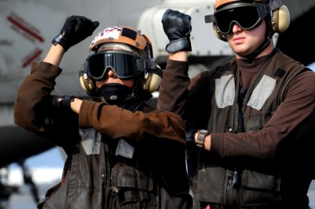 US Navy 080828-N-3659B-371 Aviation Machinist's Mate Airman Shawn Connors mimics the movements of Aviation Machinist's Mate Airman Carlos Hernandez during the pre-flights checks on an F-A-18C Hornet during flight operations abo