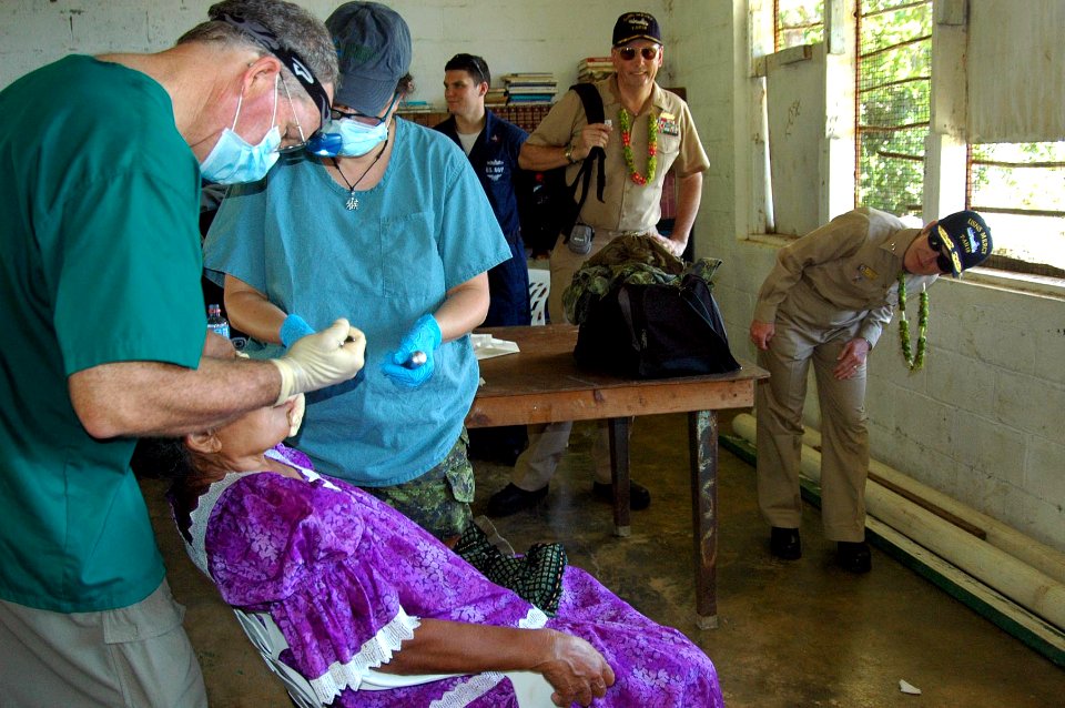 US Navy 080828-N-5086M-098 Rear Adm. Christine S. Hunter, right, and Capt. James P. Rice observe dental procedures by Mercy staff members during her visit to a Pacific Partnership Medical Civic Action Program
