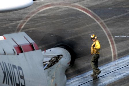 US Navy 080831-N-1635S-003 An aviation boatswain's mate (handling) guides an E-2C Hawkeye