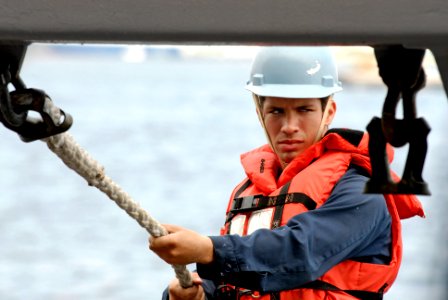 US Navy 080827-N-7280V-052 Seaman Jose Lopez tends a line during small boat operations on the port sponson aboard the amphibious command ship USS Blue Ridge (LCC 19)